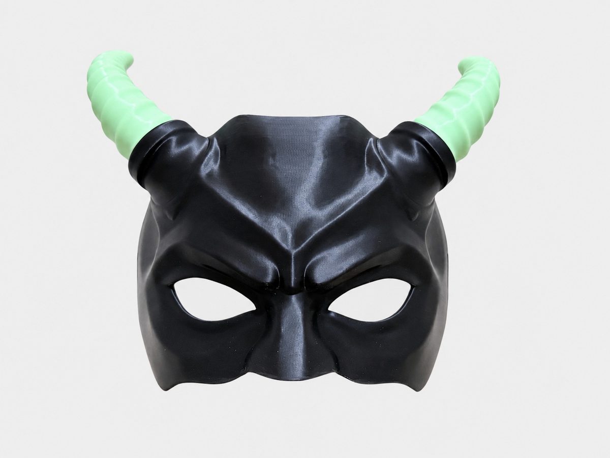 The finished demon mask: black PLA with glow-in-the-dark green horns